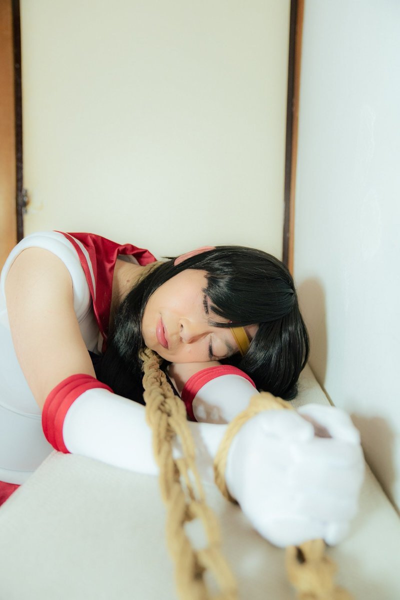 a woman with her arms tied behind her back